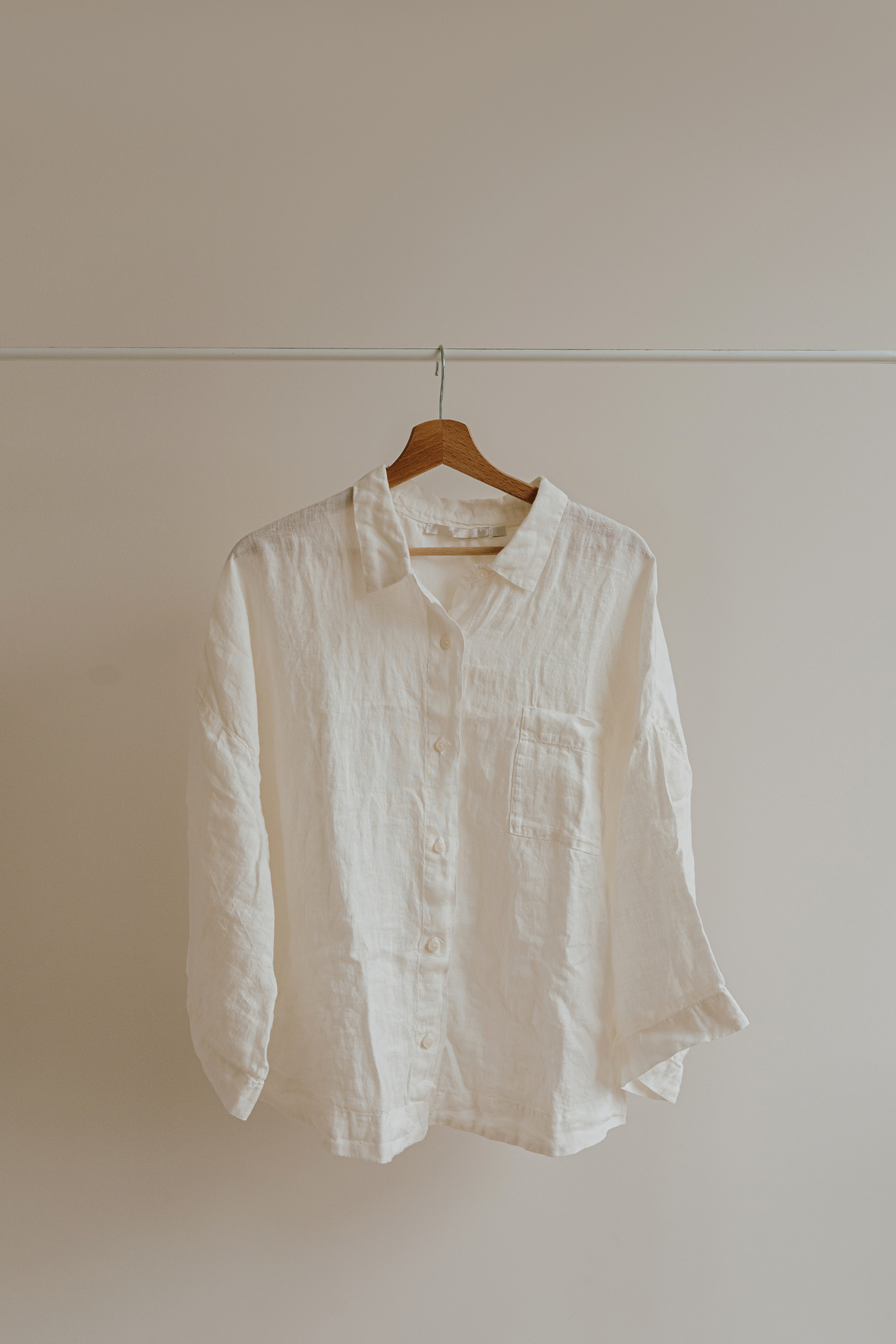 White Blouse Hanging on a Rack